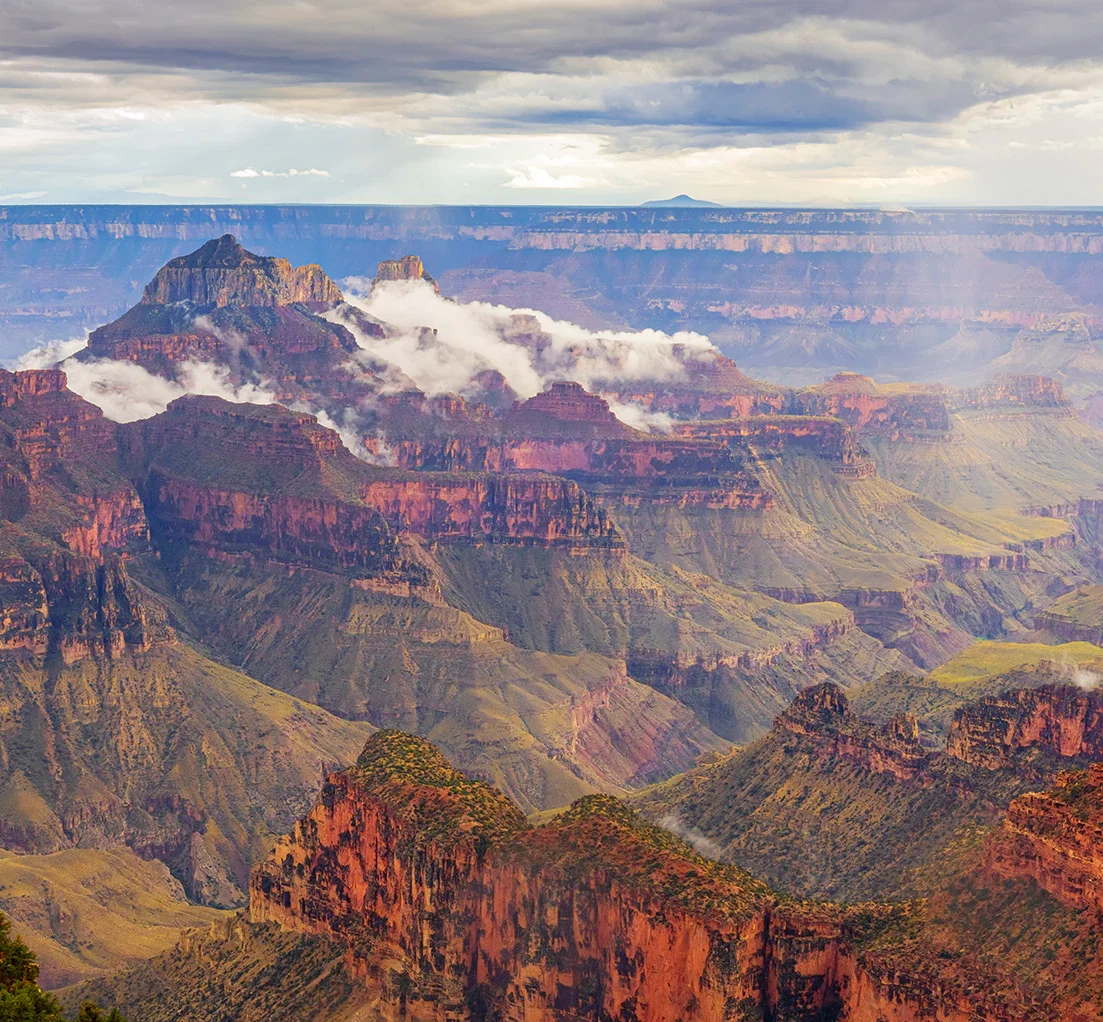 Grand Canyon layered rock formations with clouds