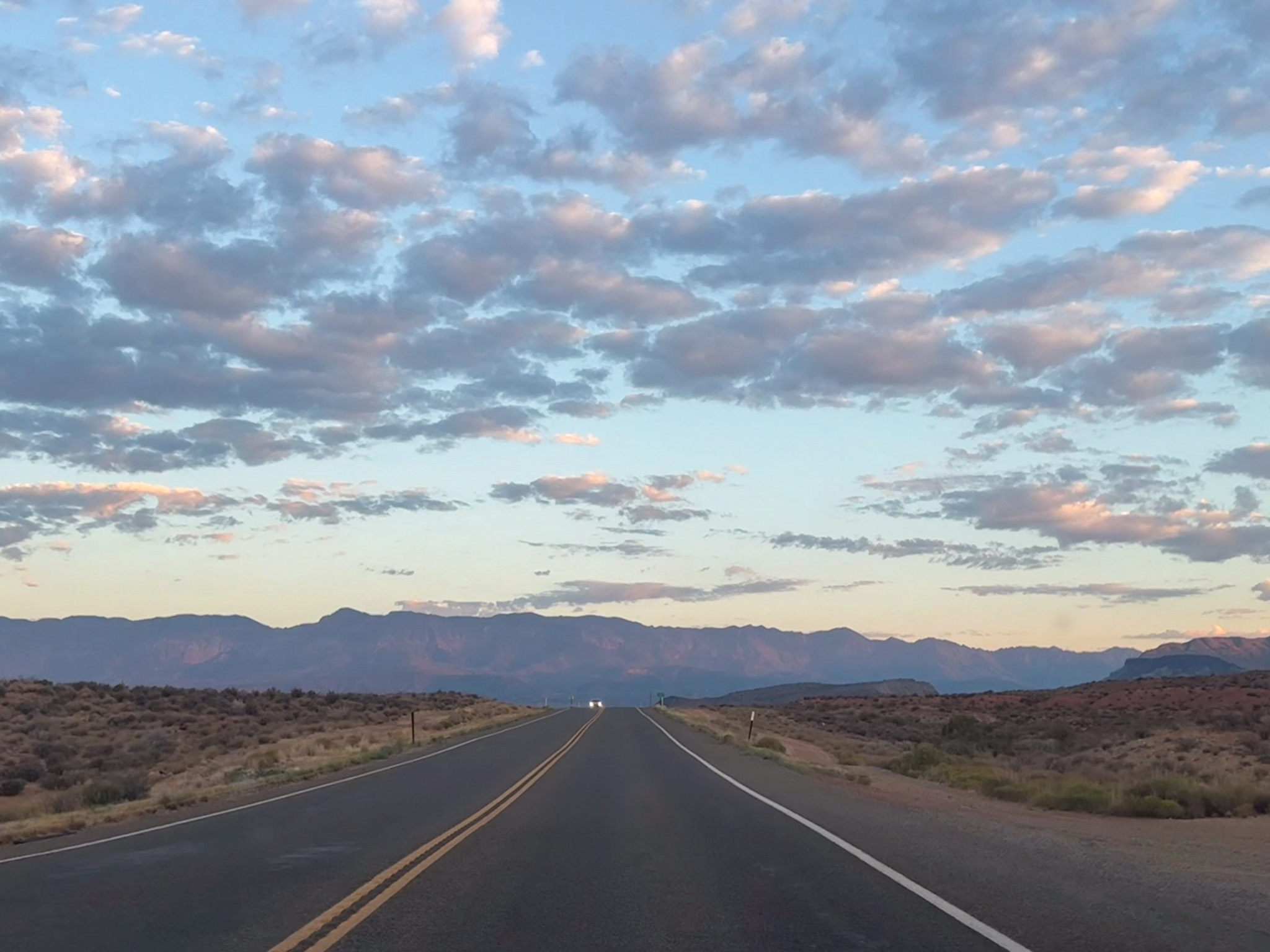 Photo depicts Scenic Route SR-9 with morning light, rising rock in the background and clouds.