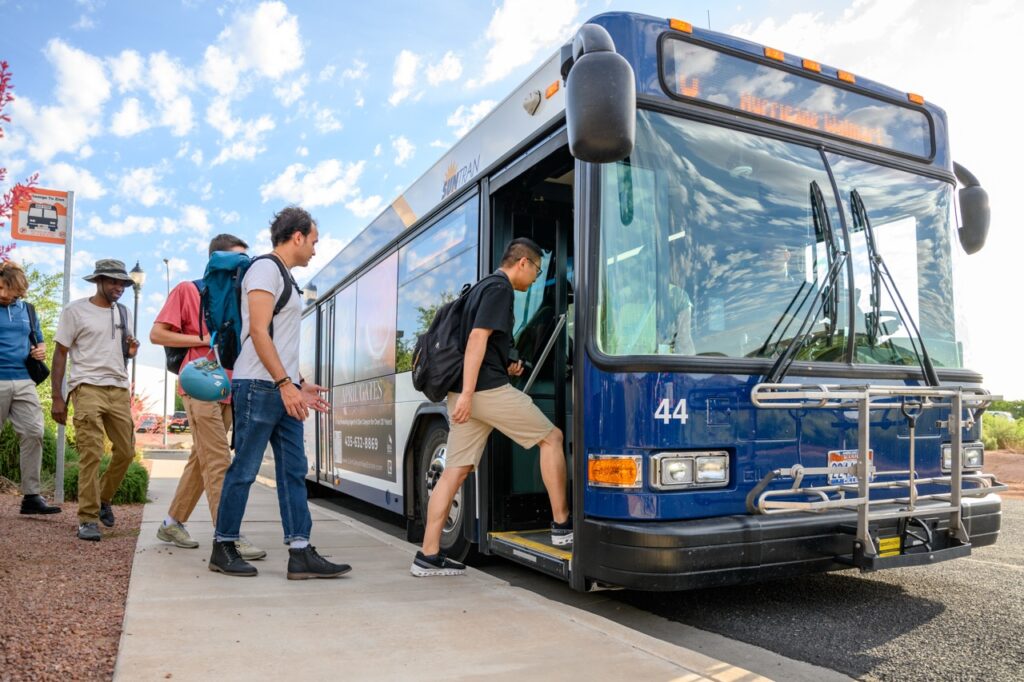 SunTran bus is stopped with passengers getting on.