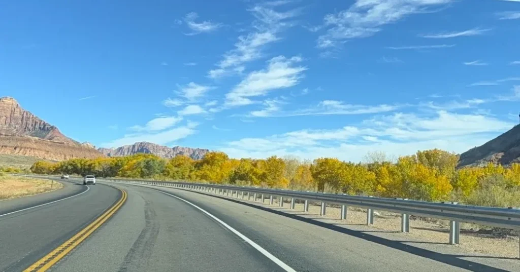 A look out from SR-9 with the bright yellow foliage of the changing trees along the side of the highway.